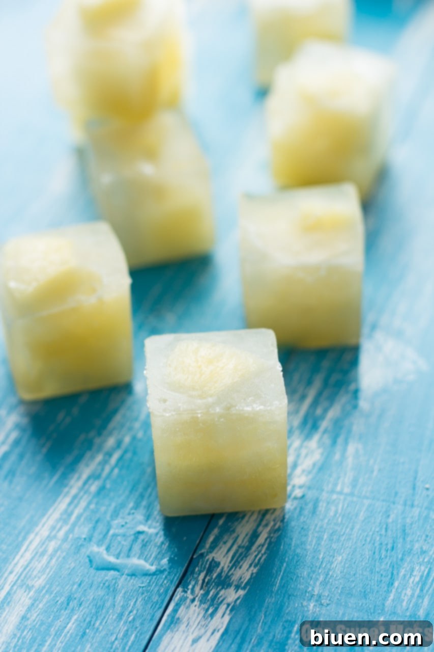 Glass of Pineapple Green Tea with a pineapple ice cube