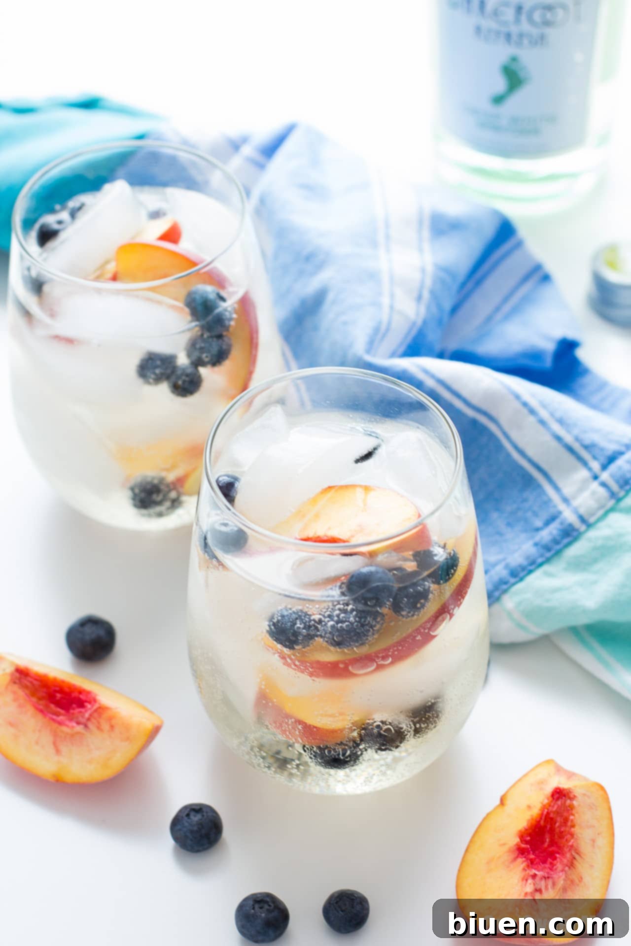 Refreshing Blueberry Peach Sangria in a pitcher with fresh fruit