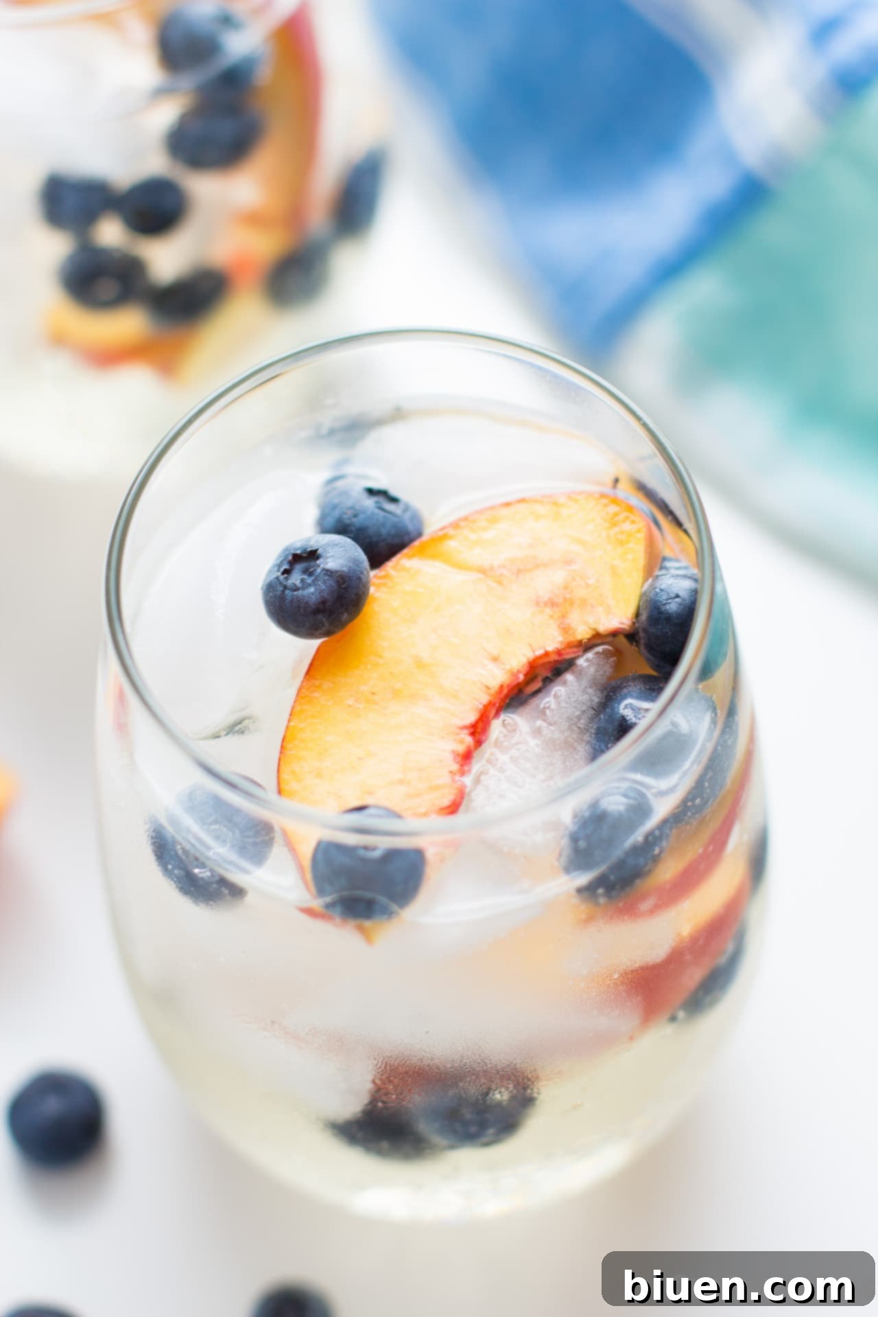 Blueberry Peach Sangria being poured into glasses
