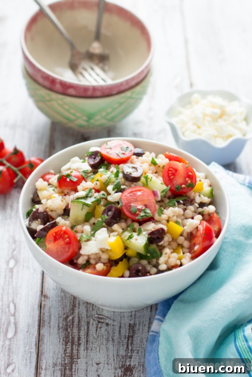 Bright and colorful Greek Israeli Couscous Salad with fresh vegetables