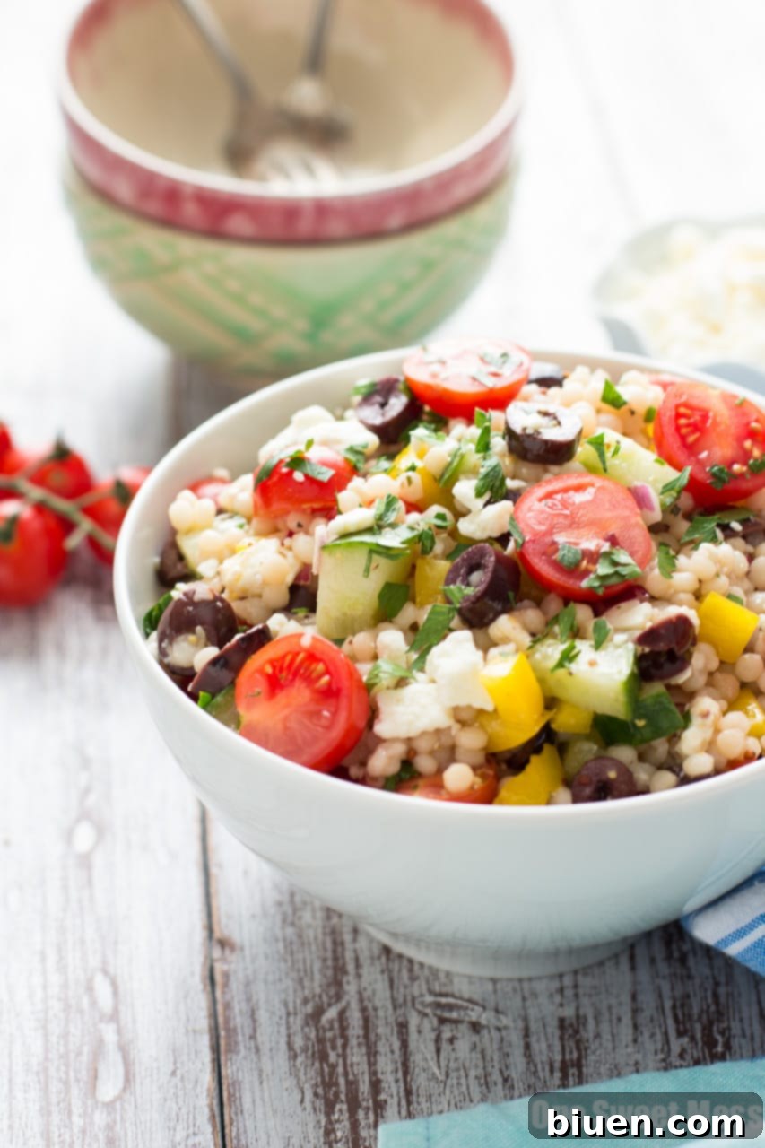 Finished Greek Israeli Couscous Salad in a serving bowl