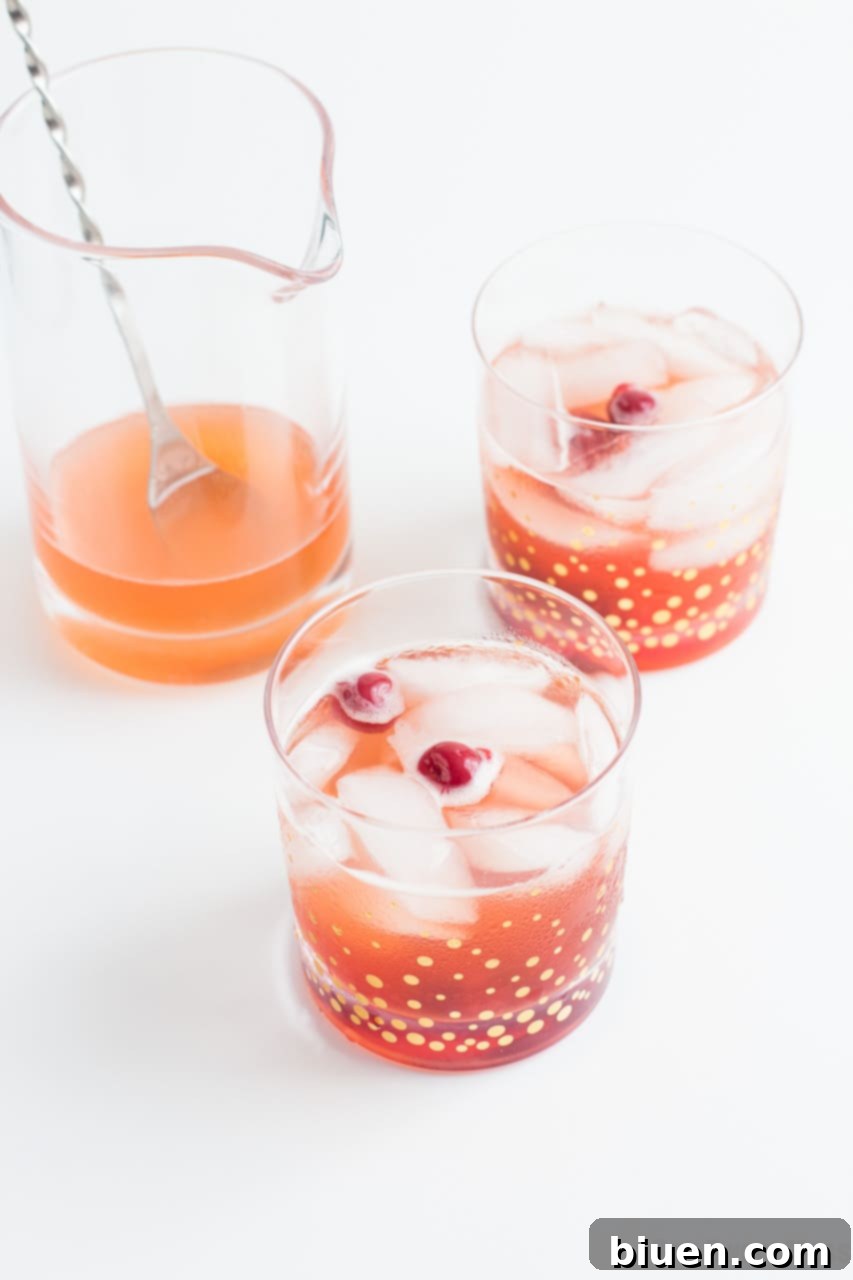 Close-up of the Shut Your Pie Hole cocktail in a rocks glass with cherry garnish.