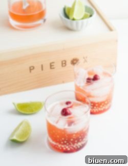 Shut Your Pie Hole Cherry Pie Cocktail with ingredients and garnishes.