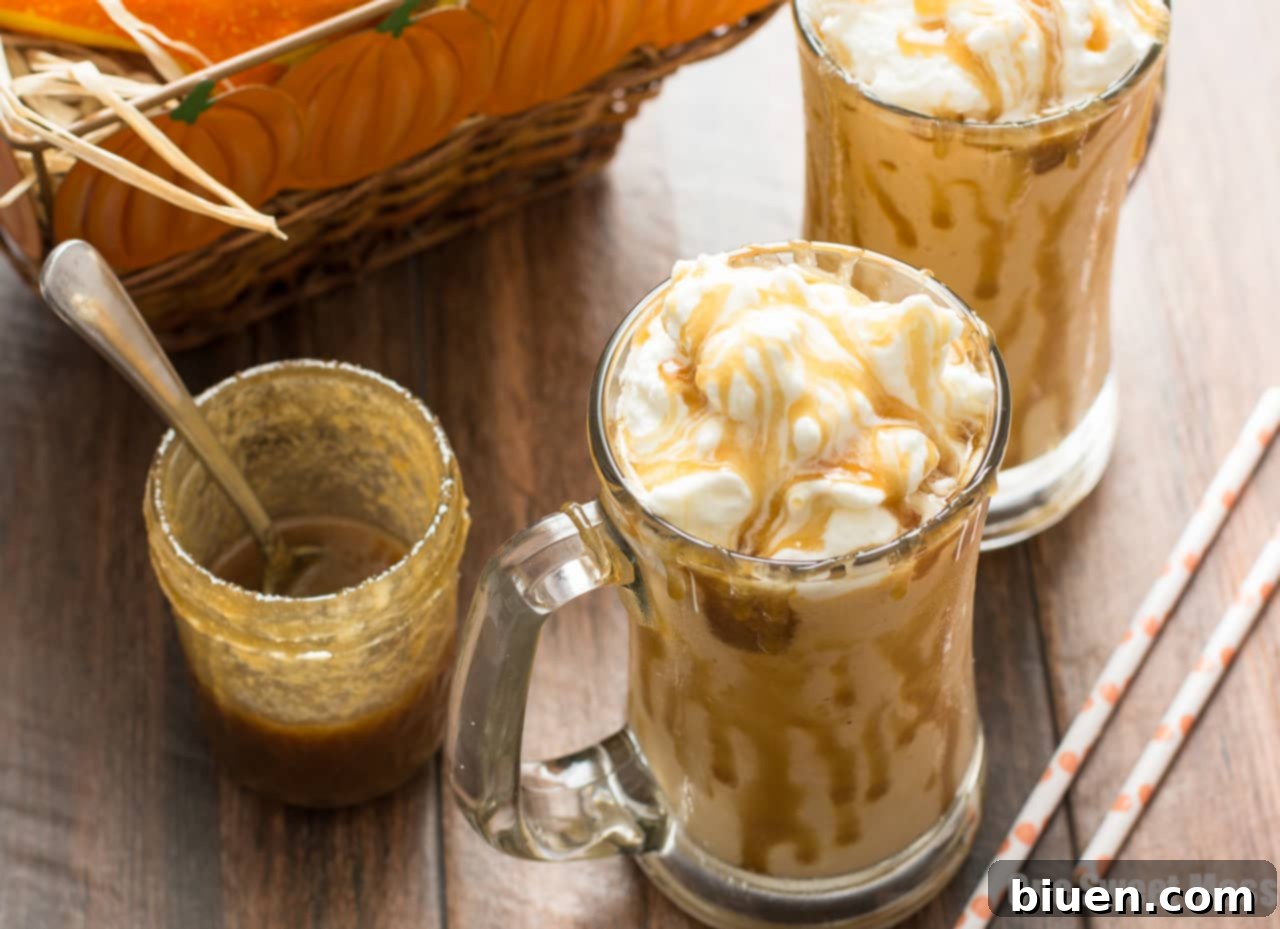 Close-up of a Caramel Pumpkin Pie Milkshake with a slice of pumpkin pie in the background