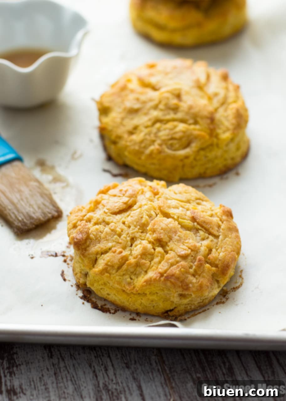 Warm Pumpkin Biscuits cooling on a wire rack after being glazed