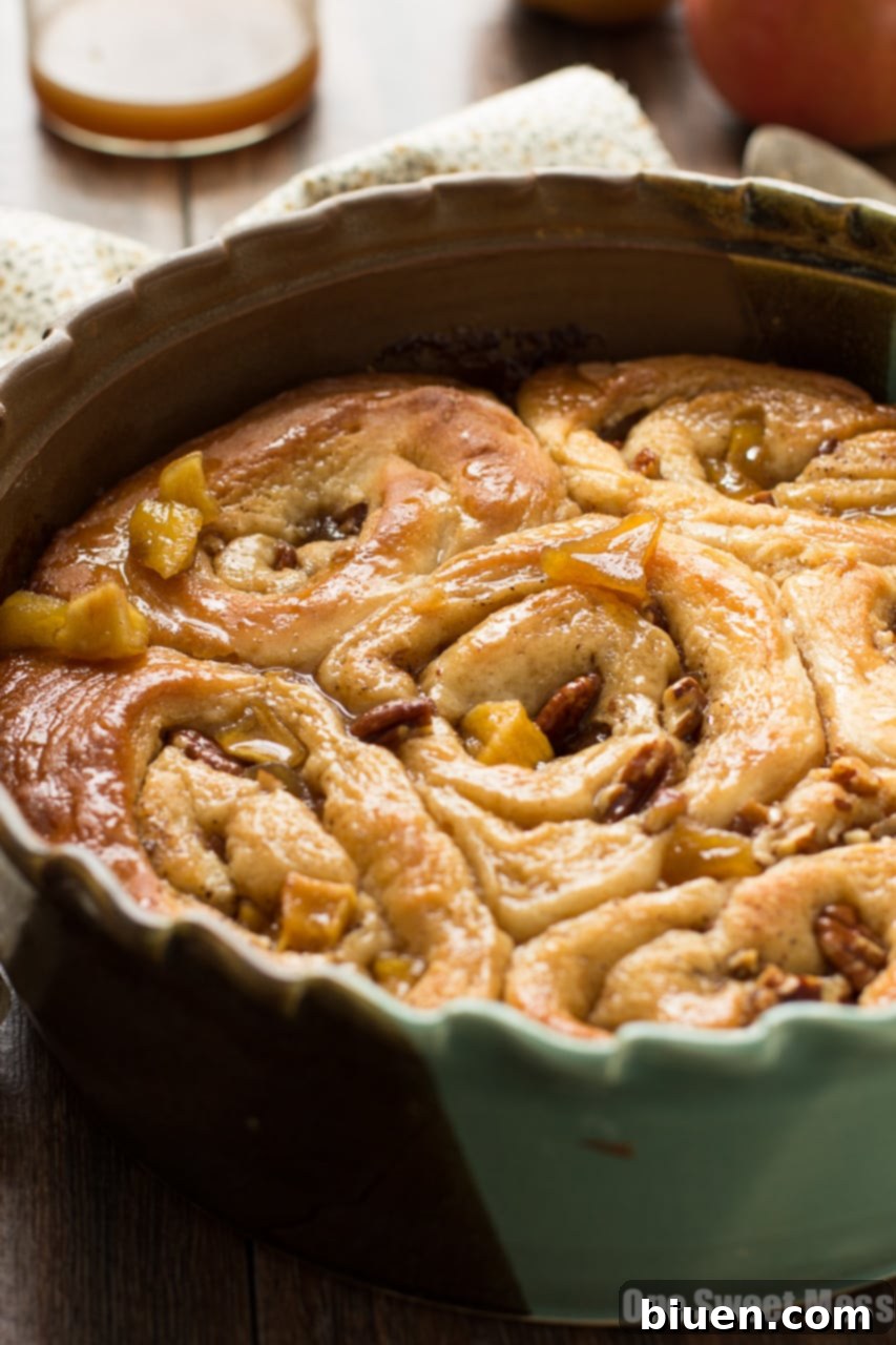 Close-up of baked caramel apple cinnamon rolls with gooey filling