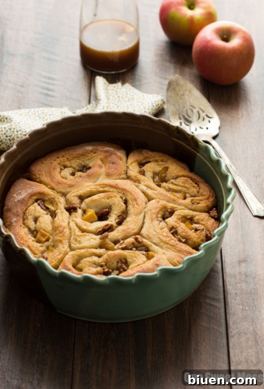 Dough being rolled for caramel apple cinnamon rolls