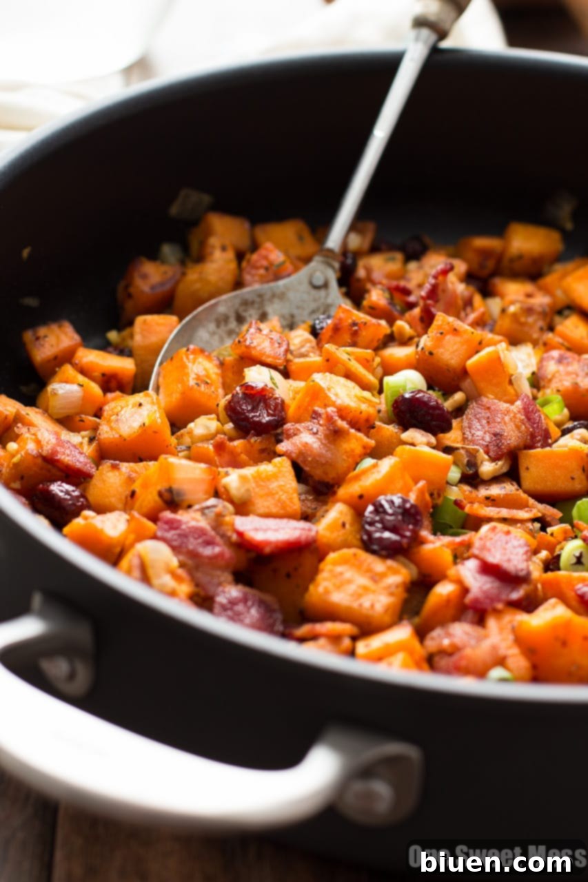 Close-up of Cranberry-Walnut Sweet Potato Hash with a fork taking a bite