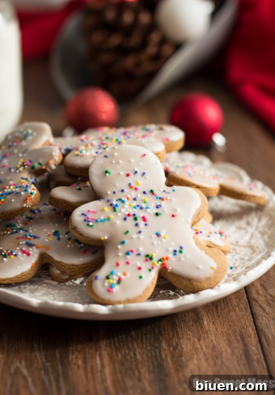 A close-up of Glazed Gingerbread Men, showing their smooth sweet glaze and colorful sprinkles.