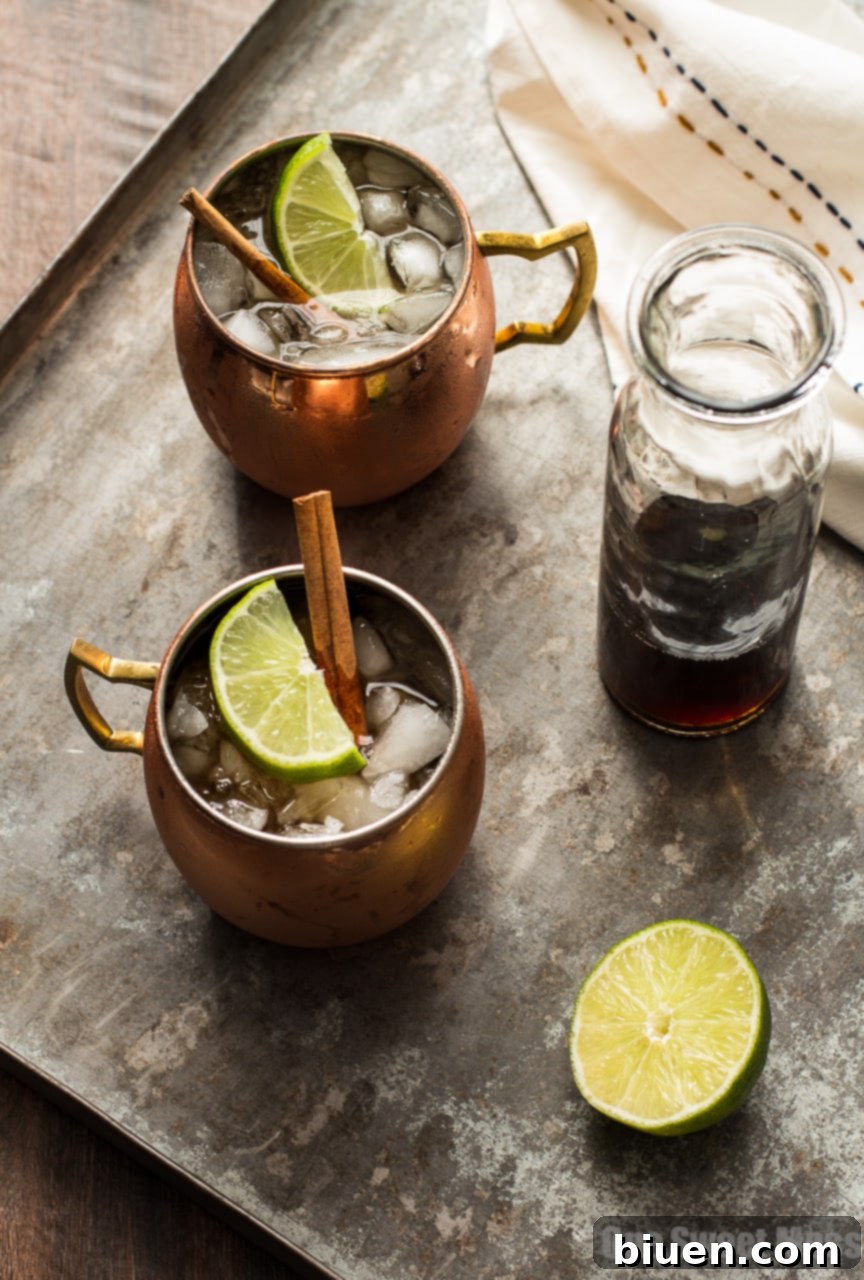The Mid-Winter Mule: This bourbon-infused cocktail combines fruity Pimm's No.1, ginger beer, and homemade cinnamon simple syrup, showcased with fresh lime and cinnamon sticks.