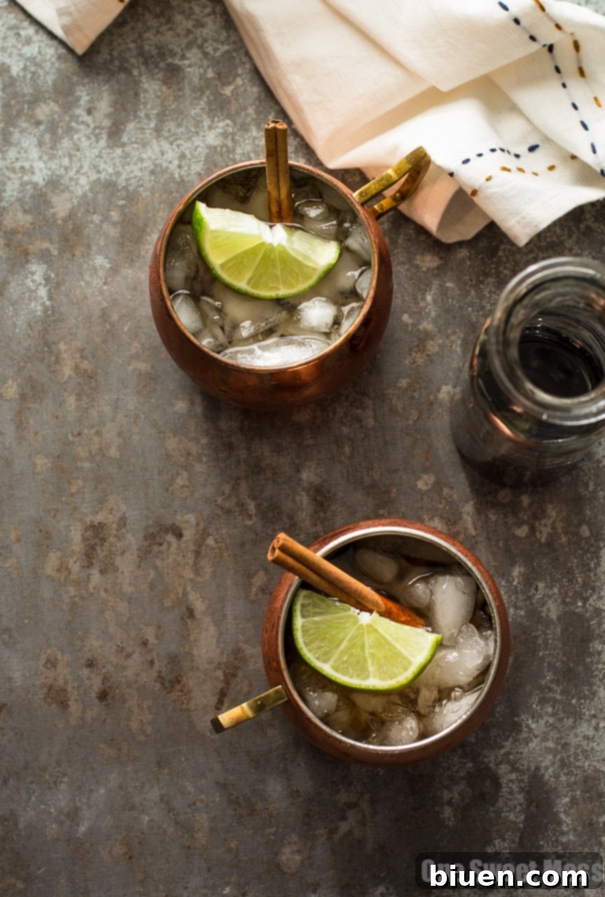 The Mid-Winter Mule: This bourbon-infused cocktail combines fruity Pimm's No.1, ginger beer, and homemade cinnamon simple syrup, elegantly garnished in a copper mug.
